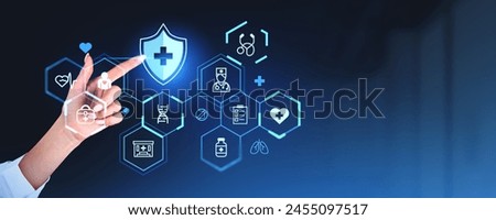A hand interacting with futuristic medical icons and symbols on a dark blue background, representing healthcare technology