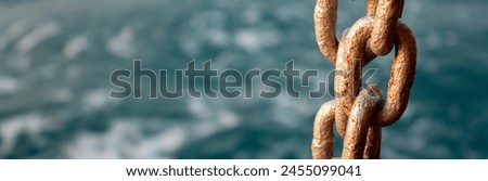 Anchor chain and sea. Chain close-up on the background of the sea at sunset. Sea waves in the evening out of focus.