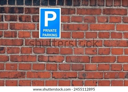 Private parking sign on red brick wall