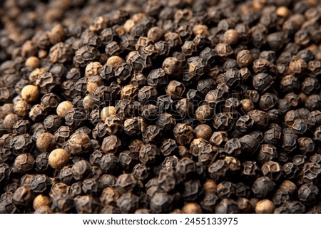 Black pepper shines in this captivating photo, adding depth and flavor to dishes worldwide. With its bold taste and aroma, it's a kitchen essential. Explore its culinary magic here!