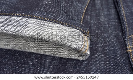 Rolled jeans hem, fashion detail, stock photo.