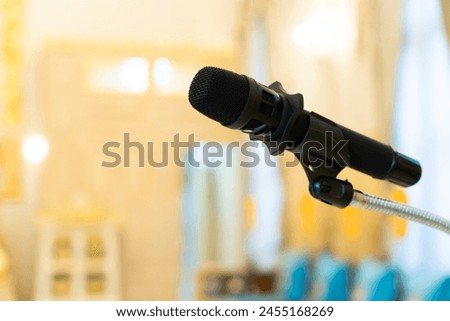 Close-up shot of microphone on bokeh light background.