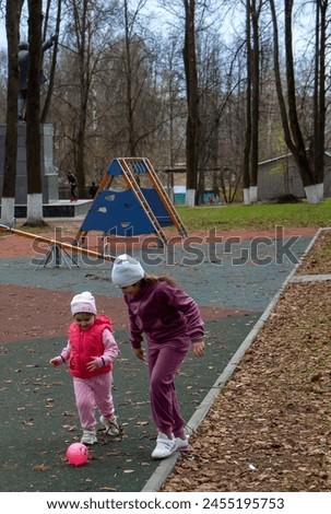 Little girls playing in a park ap outdoor in early spring on the eve of children's day