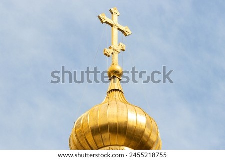 The golden dome and the cross of the Orthodox church against the blue sky and clouds. Church of St. Mary Magdalene, Jerusalem. Royalty-Free Stock Photo #2455218755