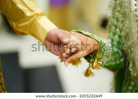 Its a bride and grooms hand picture, when a groom holds the hand of bride for the first time