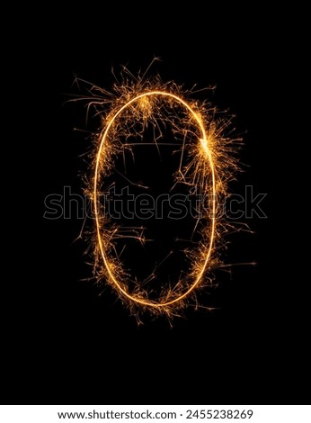 Digit 0 or zero made of bengal fire, sparkler fireworks candle isolated on a black background. Party dark backdrop