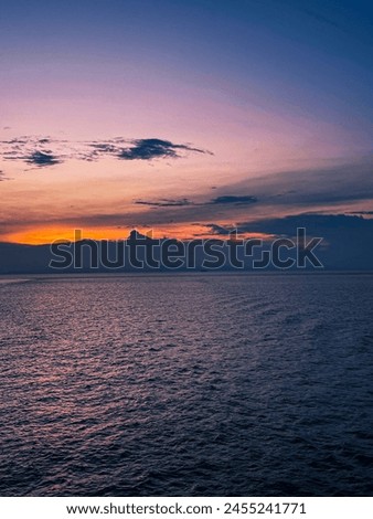Orange sunset and sea are the best views in the world Royalty-Free Stock Photo #2455241771