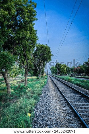 there is a train track that is next to a tree, leading lines, rail tracks, railways, in the distance, hdr photo, shot on iphone 1 3 pro max, lonely scenery yet peaceful!!, hdr shot.