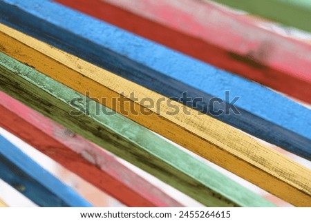 A group of multicolored wooden boards stacked on top of each other, creating a vibrant visual arrangement. Royalty-Free Stock Photo #2455264615