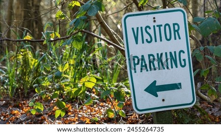 A Visitor Parking sign in a country setting
