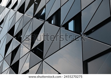 The outer covering of a building. A perspective photograph of the outer covering prepared with triangular forms, taken upwards. Royalty-Free Stock Photo #2455270275