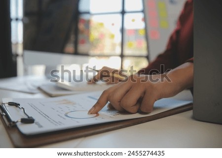 
Cropped image of professional businesswoman working at her office via laptop, young female manager using portable computer device while sitting at modern loft, flare light, work process concept