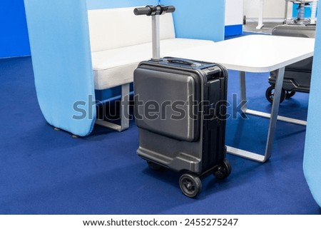 Electric scooter suitcase at the airport. The future of baggage Royalty-Free Stock Photo #2455275247