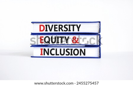 DEI diversity equity and inclusion symbol. Concept words DEI diversity equity and inclusion on books. beautiful white background. Business DEI diversity equity and inclusion concept. Copy space.