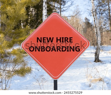 New hire onboarding symbol. Concept words New hire onboarding on beautiful red road sign. Beautiful forest snow blue sky background. Business new hire onboarding concept. Copy space.