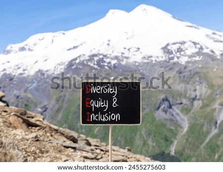 DEI diversity equity and inclusion symbol. Concept words DEI diversity equity and inclusion on blackboard. Beautiful Elbrus background. Business DEI diversity equity and inclusion concept. Copy space.