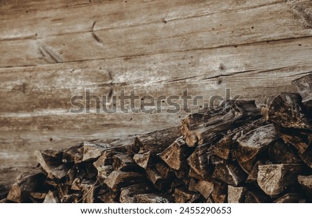 Chopped firewood pile. Woodpile board wall. Wood. Old dry pine wooden heap. Brown color textured background. Natural resources. Rural solid fuel. Winter preparation. Rustic style pattern. Woodworking.