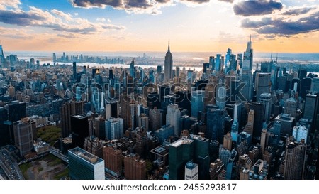 Skyline of modern New York, the USA. Majestic skyscrapers on the waterfront under the cloudy sky at daytime.
