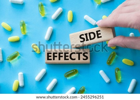 Side Effects symbol. Wooden blocks with words Side Effects. Beautiful blue background with pills. Doctor hand. Medicine and Side Effects concept. Copy space.