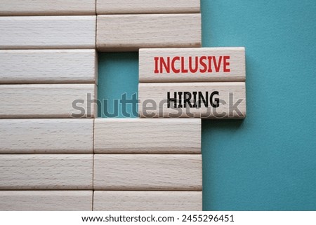 Inclusive Hiring symbol. Wooden blocks with words Inclusive Hiring. Businessman hand. Beautiful grey green background. Business and Inclusive Hiring concept. Copy space.