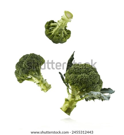 Fresh raw Brocolli cabbage falling in the air isolated on white backround. Healthy food levitation. High resolution image