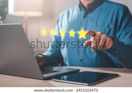 feedback, evaluation, management, marketing, rate, performance, report, result, review, satisfaction. A man is pointing at a laptop screen with five stars on it.