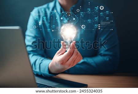 imagination, insight, invention, solution, strategy, visionary, inspiration, innovation, light bulb, creativity. A man is holding a light bulb in his hand. Concept of innovation and creativity.
