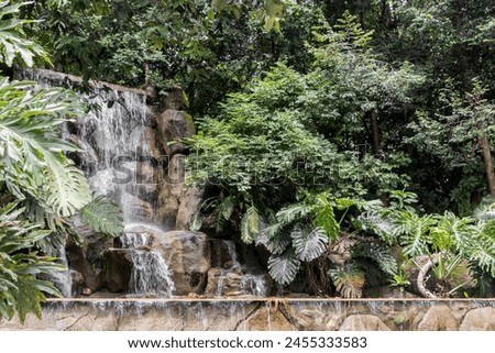 Stunning and beautiful waterfall in the Perdana Botanical Gardens in Kuala Lumpur, Malaysia.