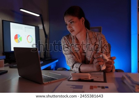 Asian businesswoman is stressed and bored from working long hours on laptop. Tired young woman with a headache at the office Feeling sick at work Office syndrome concept.