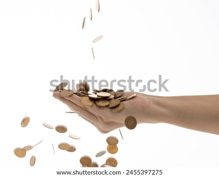 Coins falling into people hand