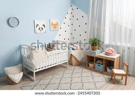 Stylish interior of children's room with baby crib and shelving unit