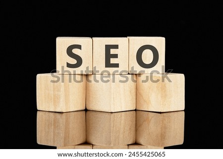 SEO Search Engine Optimization text on wooden cubes on a black background