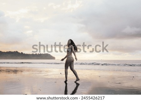 Young brunette woman enjoying on the beach