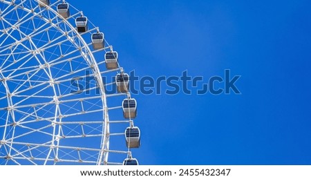 white big ferris wheel on background a clear blue sky in Navruz Park in Tashkent in Uzbekistan with copy space