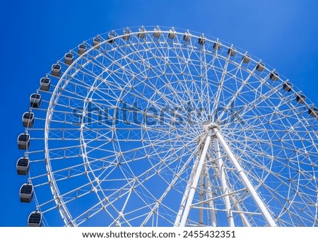 white big ferris wheel on background a clear blue sky in Navruz Park in Tashkent in summer close up