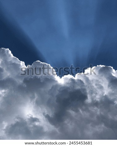Picture of cloud just before rain start.Beautiful rays coming out of cloud brings the beauty of sky.The colors forms are phenomena.White,blue,black and dark blue.