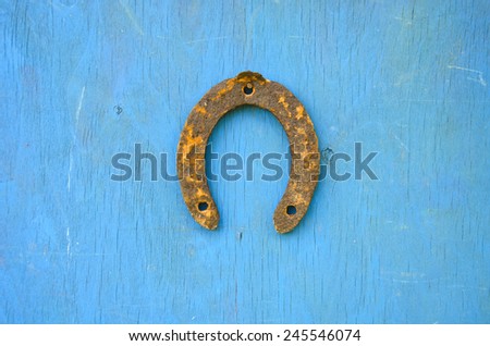 one rusty ancient horseshoe luck symbol  on old wooden wall