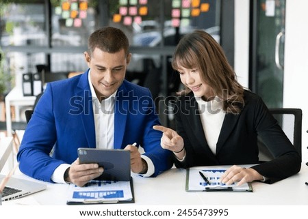 Business men and women sit and talk in the office.