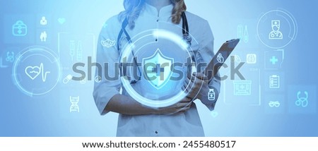 Woman doctor holding medical record and stethoscope, digital glowing hologram with health care icons, medical services and treatment. Concept of life insurance and consulting Royalty-Free Stock Photo #2455480517