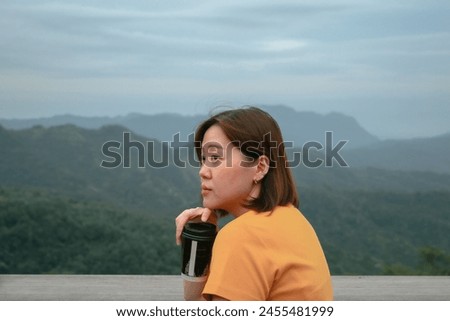 solo asian woman hipster traveler drink coffee at mountain view of outdoor bar of coffeeshop