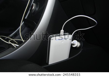 The car is charging the power bank from the usb socket. car interior Royalty-Free Stock Photo #245548315
