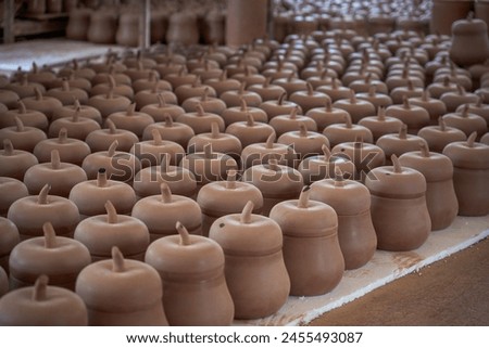 Neatly stacked clay embryos and molds in a traditional Chinese pottery factory