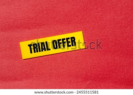 Trial offer words written on yellow paper sticker with red background