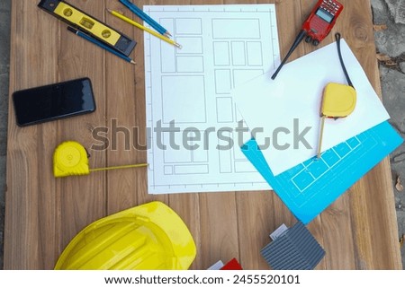 Architectural plan in top view of engineer at wooden table