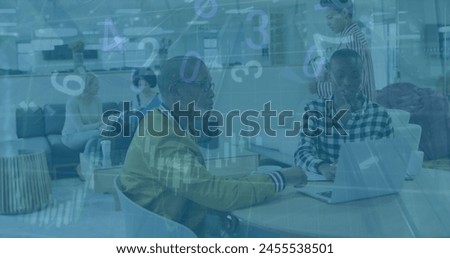 Image of financial data processing over diverse business people in office. Global business and digital interface concept digitally generated image.