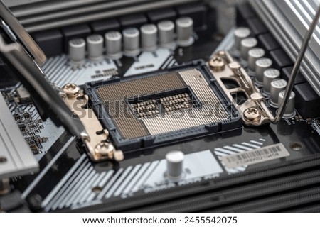 High-resolution image of an open CPU socket on a modern motherboard, detailing the intricate pin arrangement and nearby components.