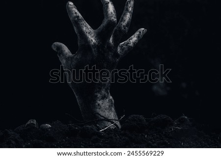 Zombie hand coming out of the ground, halloween concept