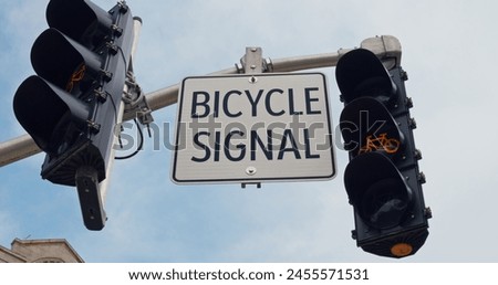 Bicycle sign coupled with a cyclist-specific signal light underscores the cities commitment to safe and efficient urban biking pathways. urban transport regulation. Bike-focused city scene.