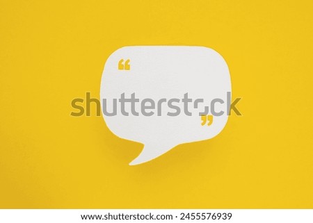 Conceptual image about communication and social media, customer feedback, real blank white speech bubble paper cut with quote sign on  yellow color background