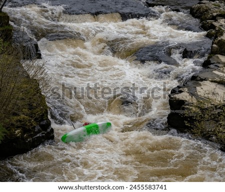 Canoeists going down the wier at Llangollen Royalty-Free Stock Photo #2455583741